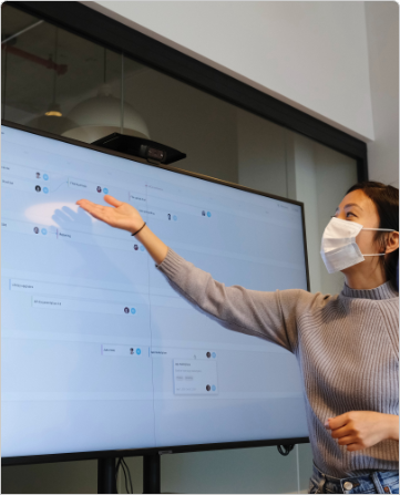 Asian woman demonstrating concept on smart board